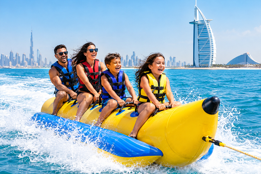 Family and friends enjoying an exciting banana boat ride on the water near Palm Jumeirah in Dubai