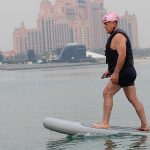 Rider gliding above the sea on an electric efoil board near Palm Jumeirah in Dubai