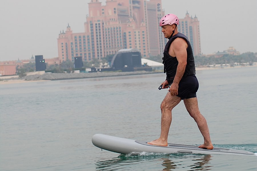 Rider gliding above the sea on an electric efoil board near Palm Jumeirah in Dubai