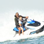 Friends enjoying jet skiing, donut rides, and other water sports near Palm Jumeirah in Dubai